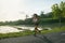 Asian Woman Running On Road At Tropical Landscape In Morning.