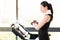 Asian woman running treadmill use smartwatch check pulse rate