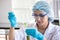 asian woman Scientist Research and Reaction woman pouring a liquid in a tube in Laboratory , science biology medicine chemistry