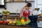 Asian woman searching the food meal recipe from the laptop computer to cook the healthy VEGAN food