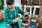 Asian woman selling herbal medicine pouring herbal concoctions into a pot