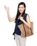 Asian woman with shoulder bag and hand present something