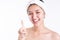 Asian woman showing cream, apply moisturizer on face. Young woman apply cream, lotion to beauty facial skin. Smiling beautiful