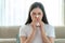 Asian woman sick and sad with sneezing on nose and cold cough on tissue paper because influenza and weak or virus bacteria from