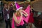 Asian woman singer in santa claus hat with a microphone singing and dancing in Christmas party and friend in restaurant.