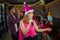 Asian woman singer in santa claus hat with a microphone singing and dancing in Christmas party and friend in restaurant.