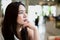 Asian woman sit on the chair in blur background restaurant. she is waiting for someone.