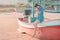 Asian woman sitting on a Beach boat relaxing for summer beach vacation concept