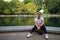 Asian Woman sitting by Conservatory Water in Central Park