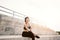 Asian woman smile in sportswear and sitting after jogging