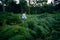 Asian woman smiling face standing in heart of green fern leaves of phu hin rongkla thailand national park