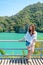 Asian woman standing by the blue sea on the beautiful scenery island