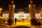 Asian woman standing in front of the gate of majestic Belgian Federal Parliament in the Palace of the Nation at night in Brussels