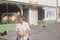 Asian woman standing in front of store looted during 1992 riots, South Central Los Angeles, California