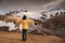 Asian woman standing on geothermal area and volcanic mountain on summer in highlands at Kerlingarfjoll, Iceland