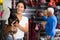 Asian woman standing in pet shop with her dog