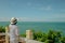 Asian woman standing relax on cliff, They looking forward to sea.