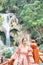 Asian woman standing on the wooden walkway in the Kuang Si Waterfall Lung Prabang, Laos