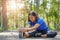 Asian woman stretch muscles at park and listening to music