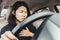 Asian woman suffering from heart attack while driving the car