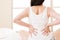 Asian woman suffers back pain backache, spinal lower problem