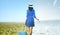 Asian woman with suitcase standing on the meadow field with winter and summer climate