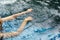 Asian woman swims with her arms because she is about to drown and her legs cramp in the swimming pool