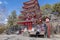 An Asian woman takes photo with the rooftop of Chureito pagoda
