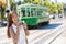 Asian woman tourist -city street lifestyle, famous tramway cable car system in San Francisco city, California during summer
