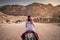 Asian woman tourist riding donkey in Petra, Jordan