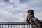 Asian Woman Tourist at Schilthorn in Switzerland with view of the Swiss Skyline.