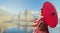 Asian woman tourists. Japanese girl wearing a kimono holding a red umbrella. Beautiful Female wearing traditional japanese kimono