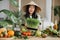 Asian woman in traditional conical hat making vegetable and fruit and microgreen sprouts salad