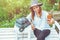 Asian woman travel nature. Travel relax. taking photos Selfie  on the bench in the park in summer