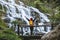 Asian woman travel relax to photograph the waterfalls beautiful. In the winter. at the waterfall mae ya chiangmai in thailand.