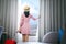 Asian woman traveller arrive to room in hotel and open curtain for enjoy fuji view