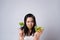 Asian woman trying to eat salad for diet isolated over white background