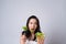 Asian woman trying to eat salad for diet isolated over white background