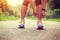 Asian woman tying shoelace on fossil forest trail