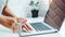 Asian woman using alcohol spray disinfectant cleaning on laptop to prevent spreading of the coronavirus at Home