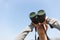 Asian woman using binocular for looking up