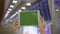 Asian woman using black mobile tablet device with green screen in terminal hall while waiting her flight at the departure gate in