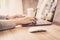 Asian woman using computer laptop for working on wooden table