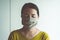 Asian woman using mask protect PM 2.5 because pollution in house,Young women got nose allergy