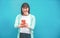 Asian woman using smartphone with blue background - Happy chinese girl having fun with new trends technology - Fashion, tech and