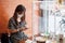 Asian woman using smartphone during dining time in restaurant with separated of shield plastic partition, protect coronavirus