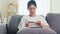 Asian woman using tablet, credit card buy and purchase e-commerce internet in living room from home when social distancing stay at