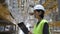 asian woman warehouse worker with clipboard. racks with export. employee manager checks goods