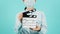 Asian woman wear face mask or medical mask and hand`s hold clapper board or movie slate use on green mint or Tiffany Blue