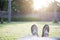 Asian woman wearing bare foot in brown slippers lay on green grass for relaxing